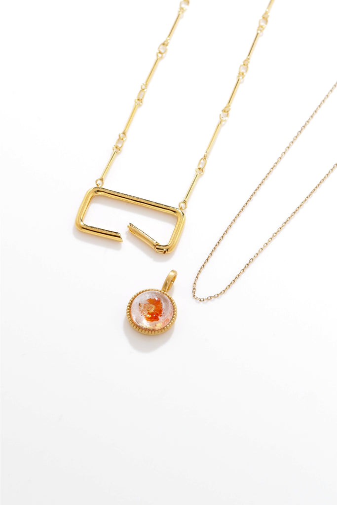 ジュエリースタジオMASHIROのアップサイクルカラーストーンジュエリー。ブラジル産・オーロラクォーツ・ラウンドカボションカットの金魚水晶ミルグレイン取り巻きチャーム（ペンダントトップ）。イエローゴールドマット