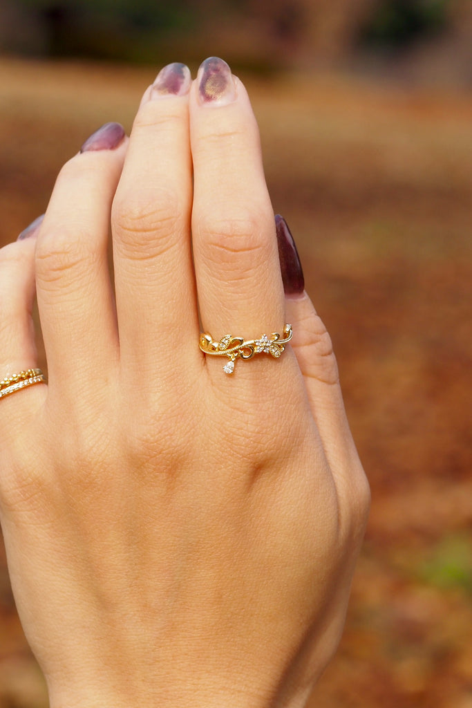 ジュエリースタジオMASHIROのアップサイクルジュエリー。南アフリカ産のダイヤモンド・ペアシェイプ・av 0.03ct・av 3*2mm・ダイヤモンド（９石）・av 0.03ct ・av0.9-1.1mm。シャンパンゴールドカラーのアラベスクリングの着用画像。